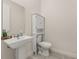 Clean half bathroom with pedestal sink, white toilet, and modern fixtures at 2057 Celebration Blvd, Kissimmee, FL 34747