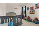 bedroom with blue-gray bed, colorful toys, and playful wall decorations at 2057 Celebration Blvd, Kissimmee, FL 34747
