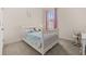 Cozy bedroom featuring a white bed frame, neutral carpeting, and natural light at 2057 Celebration Blvd, Kissimmee, FL 34747
