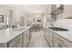 Bright, open kitchen boasts stainless steel appliances, white cabinets, and an expansive center island at 2057 Celebration Blvd, Kissimmee, FL 34747