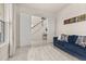 Comfortable living area with double doors, blue couch and a view of the foyer and staircase at 2057 Celebration Blvd, Kissimmee, FL 34747