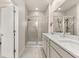 Spa-like main bathroom with a double vanity, granite counters, and a glass-enclosed shower at 2057 Celebration Blvd, Kissimmee, FL 34747