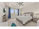 Main bedroom featuring a tray ceiling, neutral walls and carpeting, and two large windows at 2057 Celebration Blvd, Kissimmee, FL 34747