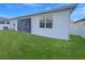 Clean backyard features a screened in porch area, lush green lawn and white privacy fence at 2164 Crosston Cir, Orlando, FL 32824