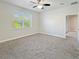 Bright bedroom with neutral carpet, large window, and ample closet space at 2164 Crosston Cir, Orlando, FL 32824