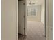 Bright bedroom view through doorway features new carpet, ceiling fan and window with blinds at 2164 Crosston Cir, Orlando, FL 32824