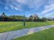 Dog park features green lawn, waste station, trash can and sidewalk at 2164 Crosston Cir, Orlando, FL 32824
