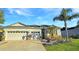 Stunning two-car garage home with a well-manicured lawn and tropical landscaping at 2164 Crosston Cir, Orlando, FL 32824