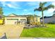Charming single-Gathering home with lush lawn, palm trees, and a convenient two-car garage at 2164 Crosston Cir, Orlando, FL 32824