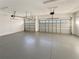 Well lit, spacious two car garage with epoxy floor featuring two garage door openers at 2164 Crosston Cir, Orlando, FL 32824