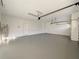 Spacious garage featuring painted floor, water heater, door to interior, and garage door opening at 2164 Crosston Cir, Orlando, FL 32824