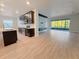 Open kitchen with dark cabinets, stainless appliances, and island flowing into the living area at 2164 Crosston Cir, Orlando, FL 32824