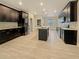 Spacious kitchen featuring dark cabinets, stainless appliances, and an island with a sink at 2164 Crosston Cir, Orlando, FL 32824
