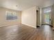 Open living room featuring wood-look floors, a modern chandelier, and plenty of natural light at 2164 Crosston Cir, Orlando, FL 32824