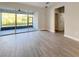 Living space featuring wood-look tile, sliding doors to an outdoor patio, and neutral walls at 2164 Crosston Cir, Orlando, FL 32824