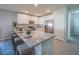 Modern kitchen featuring stainless steel appliances, granite counters, and an island with seating at 246 Cheshire Ct, Kissimmee, FL 34758