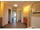 Bathroom featuring a vanity, glass enclosed shower, and arched opening to the bedroom with wood-look flooring at 257 Lancaster Dr, Davenport, FL 33897