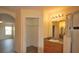 Bathroom featuring a vanity, glass enclosed shower, and arched opening to the bedroom with wood-look flooring at 257 Lancaster Dr, Davenport, FL 33897