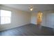 Bright bedroom featuring a ceiling fan and light gray wood-look flooring plus an arched opening to the bathroom at 257 Lancaster Dr, Davenport, FL 33897