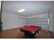 Spacious game room with a red pool table provides space for recreational activities at 257 Lancaster Dr, Davenport, FL 33897