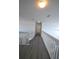 Second-floor hallway boasts sleek vinyl floors, updated lighting, and a crisp white interior at 257 Lancaster Dr, Davenport, FL 33897