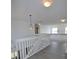 Bright, upstairs hallway features vinyl floors, a modern ceiling fan and white bannister at 257 Lancaster Dr, Davenport, FL 33897