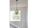 Upstairs landing area featuring neutral paint, gray vinyl floor, and a modern light fixture at 257 Lancaster Dr, Davenport, FL 33897