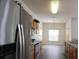 Kitchen with stainless appliances and wooden cabinetry, flowing into the dining area at 257 Lancaster Dr, Davenport, FL 33897