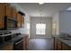Kitchen with stainless appliances and wooden cabinetry, flowing into the dining area at 257 Lancaster Dr, Davenport, FL 33897