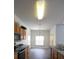 Kitchen with stainless appliances and wooden cabinetry, flowing into the dining area at 257 Lancaster Dr, Davenport, FL 33897