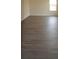 Beautiful vinyl flooring in a spacious living room with a window providing natural light at 257 Lancaster Dr, Davenport, FL 33897
