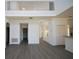 Bright living room with an open floor plan and wood floors overlooked by a second-story balcony at 257 Lancaster Dr, Davenport, FL 33897