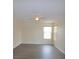 Bright living room featuring modern, gray-toned vinyl floors, ceiling fan, and natural light at 257 Lancaster Dr, Davenport, FL 33897