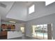 Open living room showcases high ceilings, lots of natural light, and access to the pool area at 257 Lancaster Dr, Davenport, FL 33897
