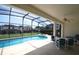 Relaxing screened-in pool area with spa and outdoor seating perfect for entertaining at 257 Lancaster Dr, Davenport, FL 33897