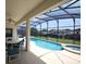 Inviting screened-in pool area with spa and dining set offers an outdoor retreat at 257 Lancaster Dr, Davenport, FL 33897