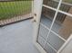 Relaxing balcony features gray flooring and metal railing overlooking the lawn at 3001 Greystone Loop # 106, Kissimmee, FL 34741