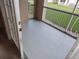 Enclosed balcony offering outdoor space with open views of the grassy area at 3001 Greystone Loop # 106, Kissimmee, FL 34741