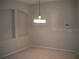 Bright dining room with neutral carpet and a modern chandelier at 3001 Greystone Loop # 106, Kissimmee, FL 34741