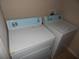 Laundry room with a white washer and dryer set at 3001 Greystone Loop # 106, Kissimmee, FL 34741