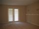 Neutral living room features double doors and lots of natural light at 3001 Greystone Loop # 106, Kissimmee, FL 34741