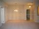 Spacious living room with neutral walls and carpet, featuring modern lighting at 3001 Greystone Loop # 106, Kissimmee, FL 34741