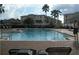 Inviting community pool with lounge chairs and building backdrop at 3001 Greystone Loop # 106, Kissimmee, FL 34741
