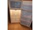 An open white refrigerator showing the interior and shelves at 3001 Greystone Loop # 106, Kissimmee, FL 34741