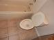 Standard toilet and tub with tile floor in an older-style bathroom at 3001 Greystone Loop # 106, Kissimmee, FL 34741