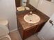 Standard vanity with laminate countertop and small mirror in a bathroom at 3001 Greystone Loop # 106, Kissimmee, FL 34741