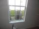 A view from the window shows the air conditioning infrastructure outside at 3001 Greystone Loop # 106, Kissimmee, FL 34741
