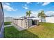 Backyard featuring above ground pool, green grass, and palms at 3211 Sweet Acres Pl, St Cloud, FL 34772