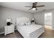 Comfortable bedroom featuring neutral colors, ceiling fan, and ensuite bathroom access at 3211 Sweet Acres Pl, St Cloud, FL 34772