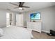 Relaxing bedroom showcasing a ceiling fan, TV, dresser, and ensuite bathroom at 3211 Sweet Acres Pl, St Cloud, FL 34772